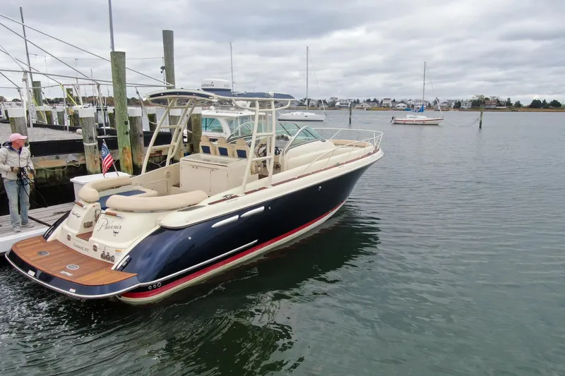Phoenix Yacht Photos Pics 2017 Chris-Craft Launch 38 boat docked in a marina, featuring elegant design and spacious seating.