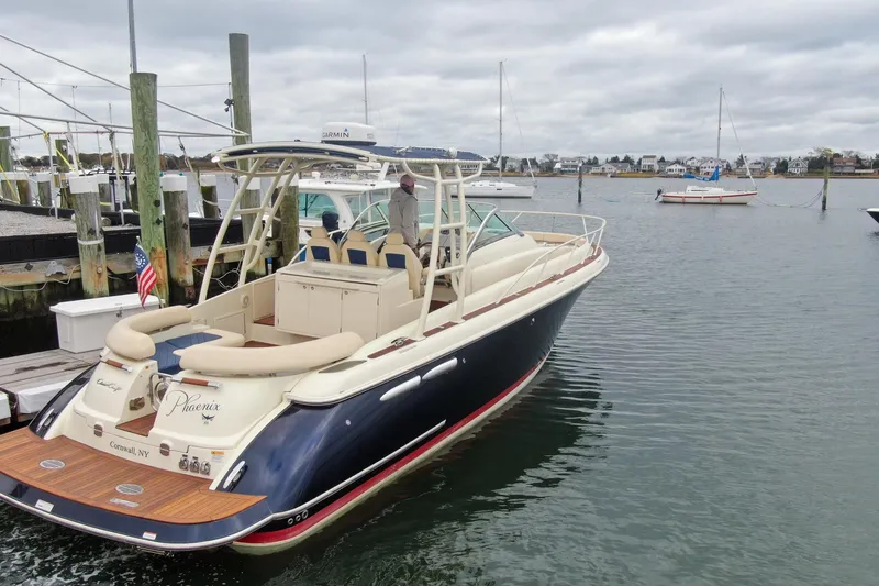 Phoenix Yacht Photos Pics 2017 Chris-Craft Launch 38 boat docked in a marina, featuring elegant design and spacious seating.