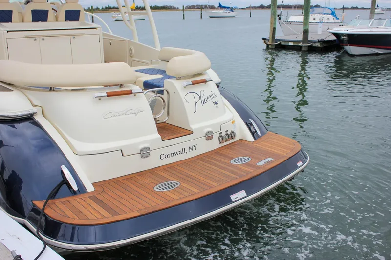 Phoenix Yacht Photos Pics 2017 Chris-Craft Launch 38 boat docked, featuring elegant teak deck and luxurious seating.