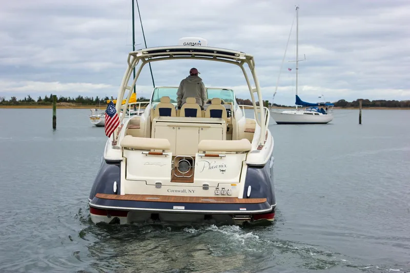 Phoenix Yacht Photos Pics 2017 Chris-Craft Launch 38 boat on water, rear view with American flag.