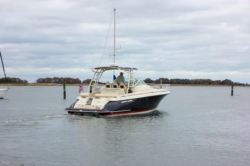 Phoenix Yacht Photos Pics 2017 Chris-Craft Launch 38 boat cruising on calm waters under cloudy skies.