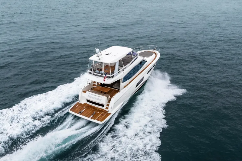 Seeworthy Yacht Photos Pics 2018 Prestige 560 yacht cruising on open water, rear view.