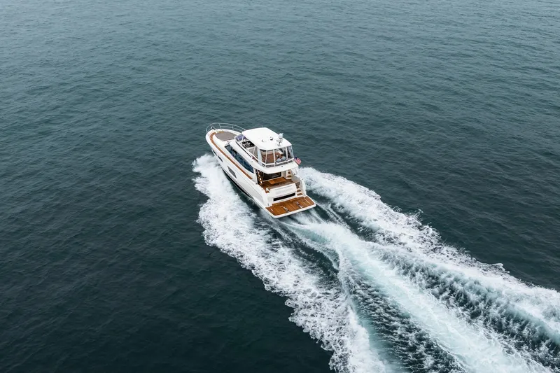 Seeworthy Yacht Photos Pics Aerial view of 2018 Prestige 560 yacht cruising on open water.