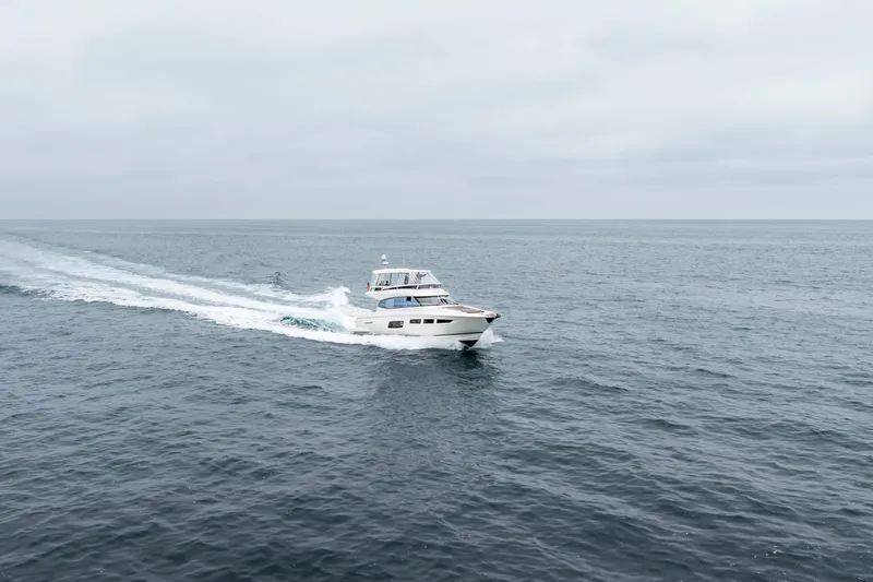 Seeworthy Yacht Photos Pics 2018 Prestige 560 yacht cruising on open sea under cloudy skies.