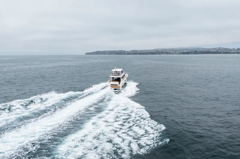 Seeworthy Yacht Photos Pics Luxury 2018 Prestige 560 yacht cruising on open sea with scenic coastline.