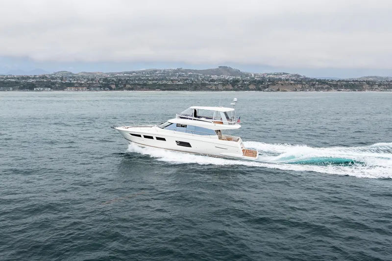 Seeworthy Yacht Photos Pics 2018 Prestige 560 yacht cruising on open water with coastal background.