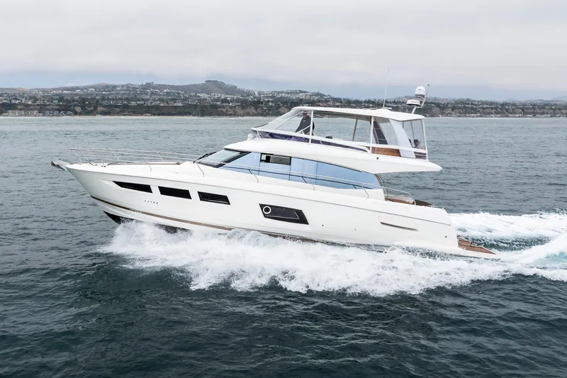 Seeworthy Yacht Photos Pics 2018 Prestige 560 yacht cruising on the ocean near a coastal city.