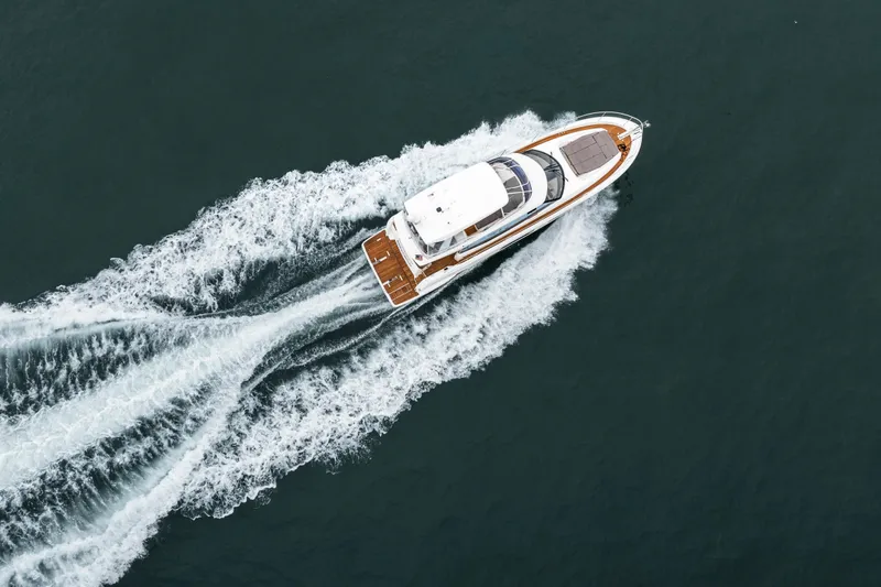 Seeworthy Yacht Photos Pics Aerial view of 2018 Prestige 560 yacht cruising on open water.
