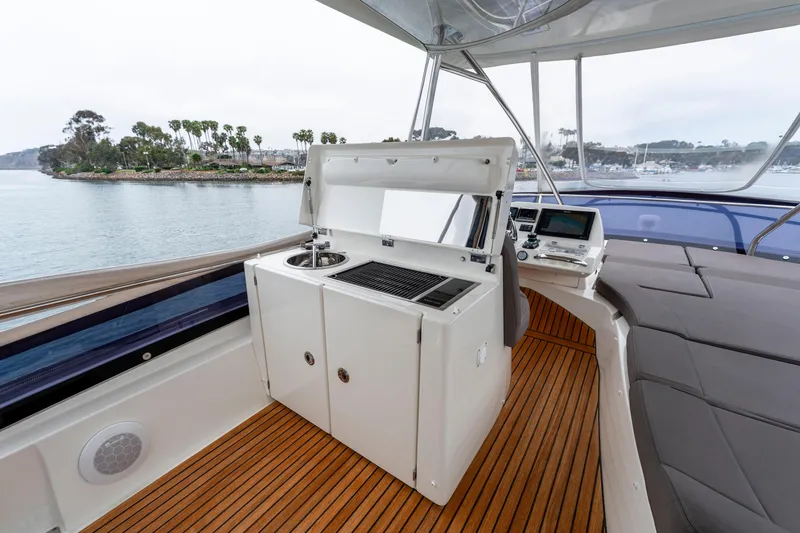 Seeworthy Yacht Photos Pics Luxurious 2018 Prestige 560 yacht interior with kitchenette and seating, overlooking serene waters.