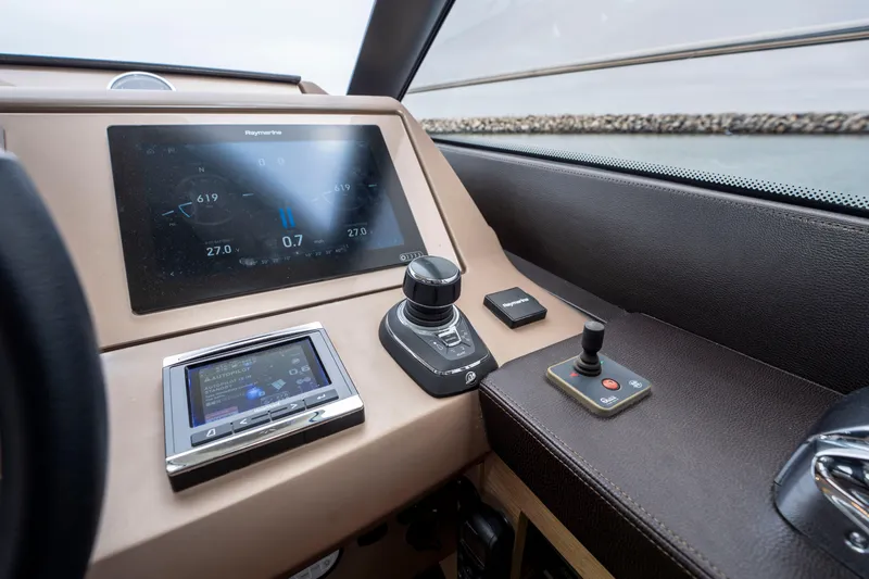 Seeworthy Yacht Photos Pics Control panel of a 2018 Prestige 560 yacht with navigation screens and joystick.
