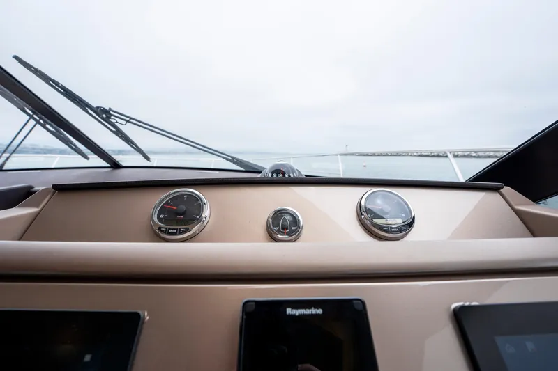 Seeworthy Yacht Photos Pics Control panel of a 2018 Prestige 560 yacht with gauges and navigation screens.