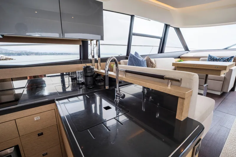 Seeworthy Yacht Photos Pics Luxurious interior of 2018 Prestige 560 yacht with modern kitchen and seating area.