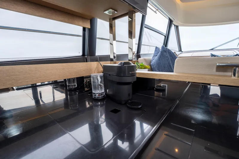 Seeworthy Yacht Photos Pics Luxurious interior of 2018 Prestige 560 yacht with modern kitchen and seating area.