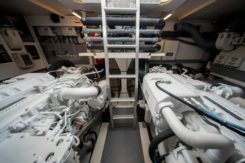 Seeworthy Yacht Photos Pics Engine room of a 2018 Prestige 560 yacht, featuring dual engines and a central ladder.