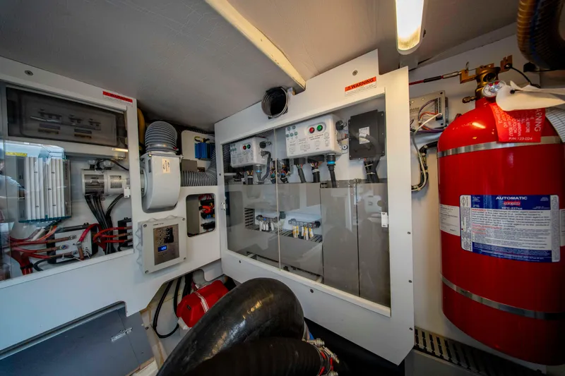 Seeworthy Yacht Photos Pics Engine room of 2018 Prestige 560 yacht with control panels and fire extinguisher.