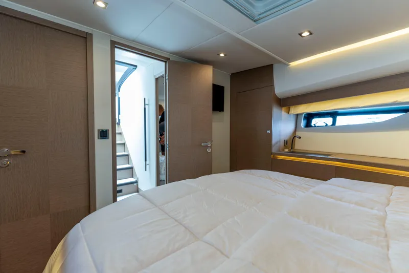 Seeworthy Yacht Photos Pics Luxurious cabin interior of 2018 Prestige 560 yacht, featuring modern design and cozy bedding.