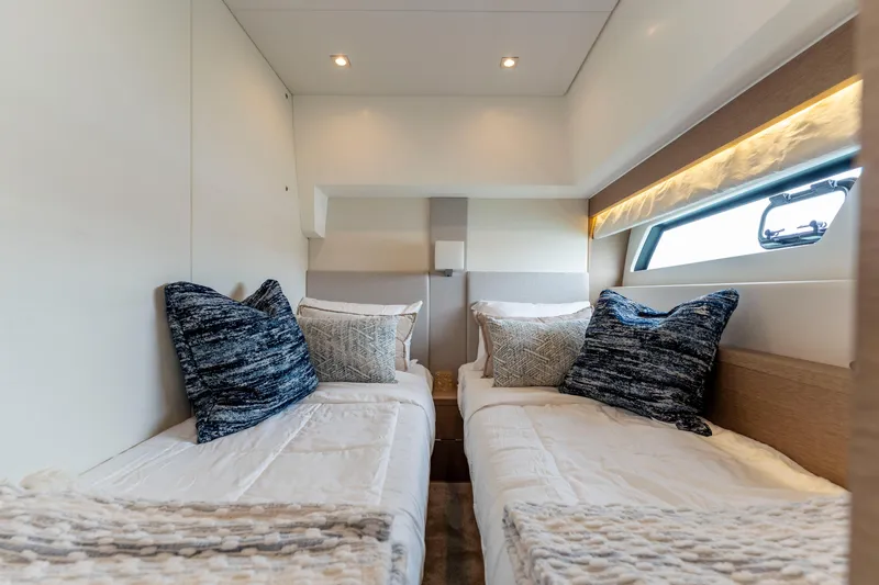 Seeworthy Yacht Photos Pics Luxurious twin cabin interior of 2018 Prestige 560 yacht with elegant bedding.
