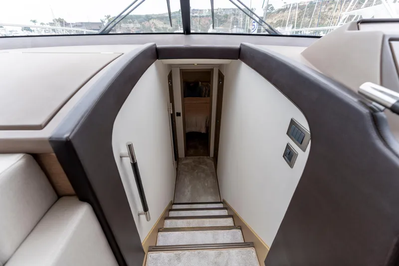Seeworthy Yacht Photos Pics Interior stairs of 2018 Prestige 560 yacht, leading to lower cabin area.