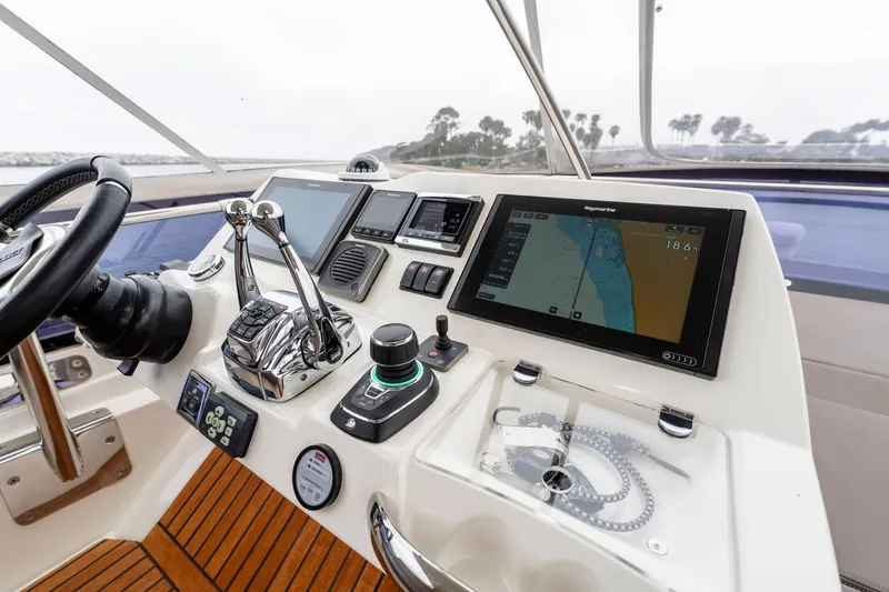 Seeworthy Yacht Photos Pics Cockpit of 2018 Prestige 560 yacht with navigation controls and display screens.