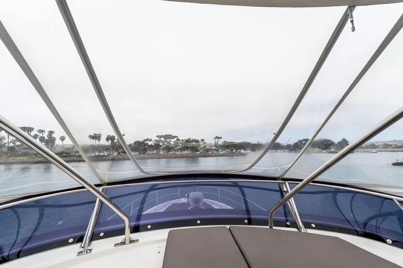Seeworthy Yacht Photos Pics View from 2018 Prestige 560 yacht's deck, overlooking calm waters and distant shoreline.