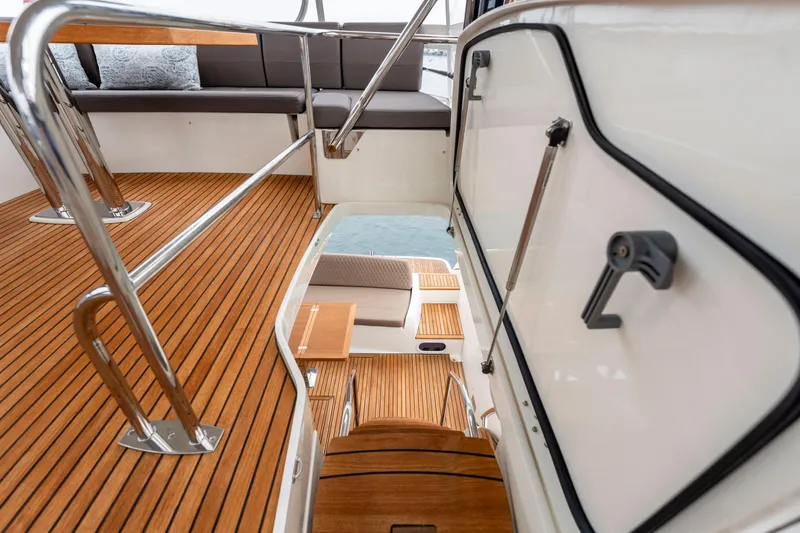 Seeworthy Yacht Photos Pics Interior view of 2018 Prestige 560 yacht with wooden flooring and seating area.