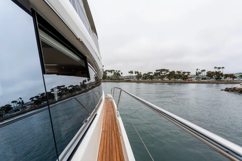 Seeworthy Yacht Photos Pics 2018 Prestige 560 yacht cruising near a scenic coastline with palm trees.