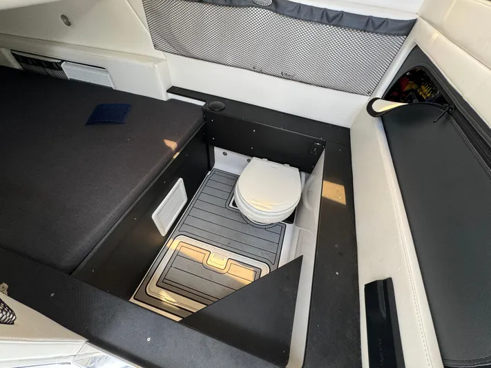  Yacht Photos Pics 2022 Nor-Tech 392 Super Fish cabin interior with compact marine toilet.