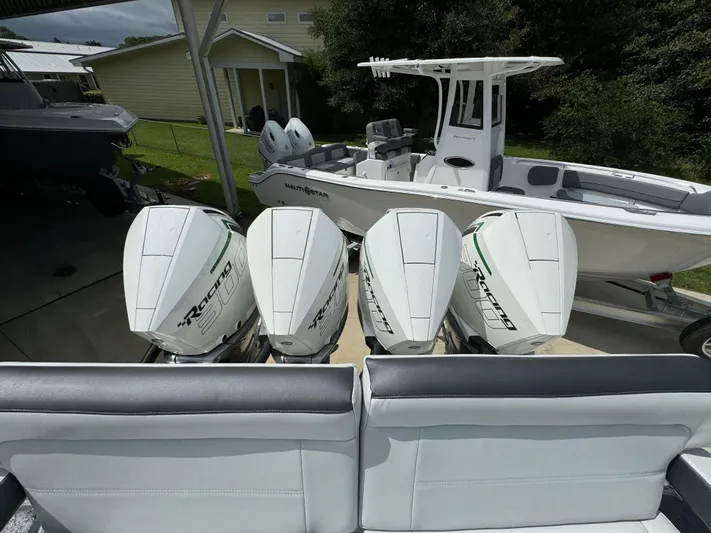  Yacht Photos Pics 2022 Nor-Tech 392 Super Fish with quad outboard engines in a driveway.