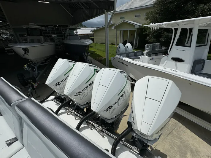  Yacht Photos Pics 2022 Nor-Tech 392 Super Fish with four powerful outboard engines in a boatyard.