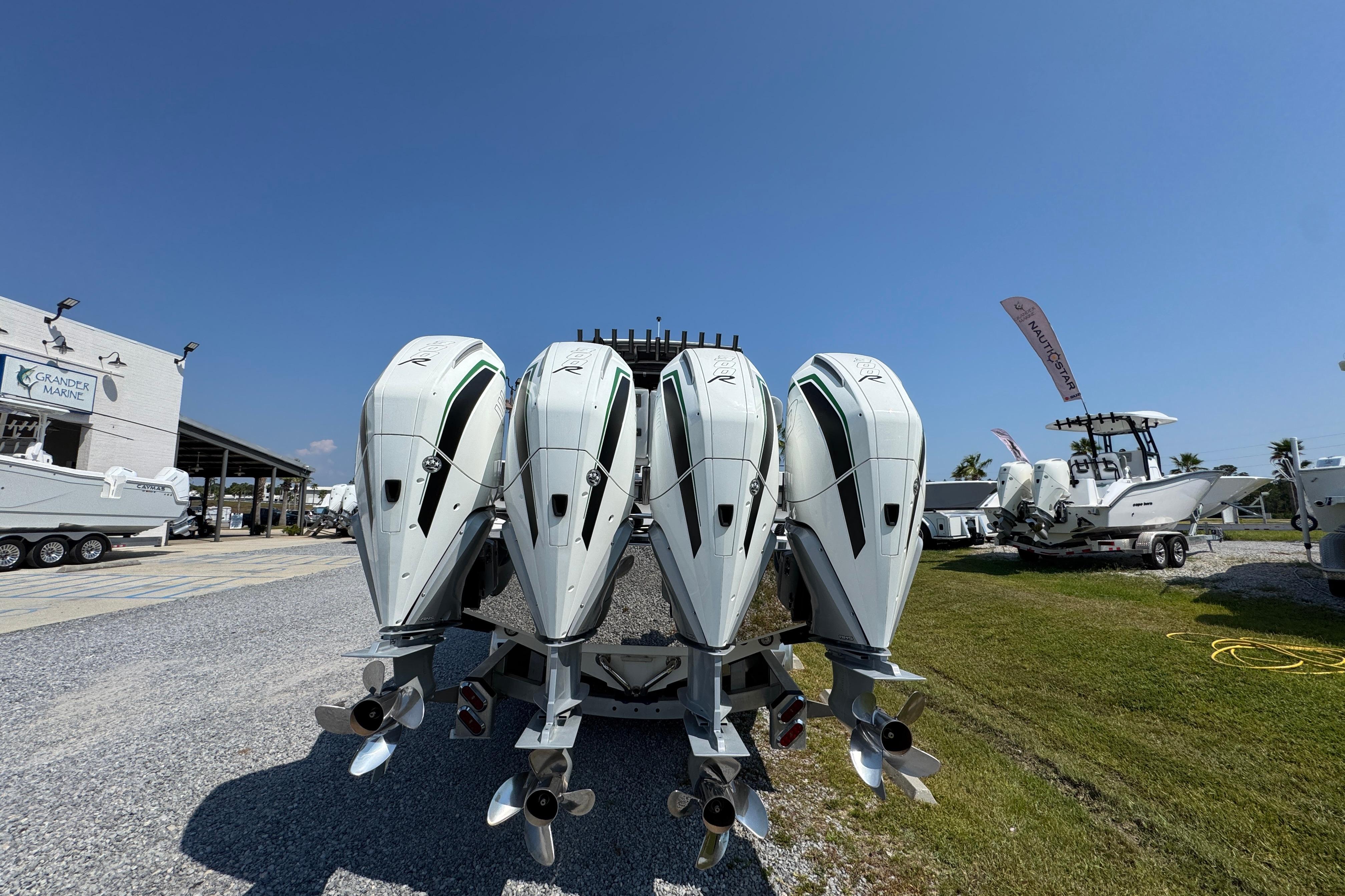 2022 Nor-Tech 392 Super Fish boat with four powerful outboard engines displayed outdoors.