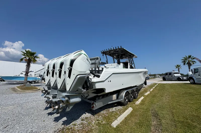  Yacht Photos Pics 2022 Nor-Tech 392 Super Fish boat with multiple outboard engines, parked on gravel.