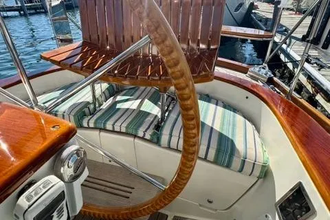 Symphony V Yacht Photos Pics Cockpit of 1999 Hinckley Sou'wester 52 sailboat with striped cushions and wooden accents.
