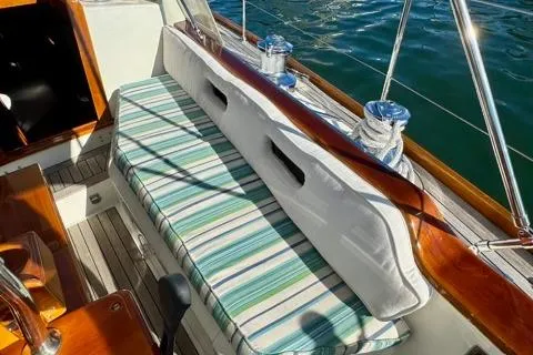Symphony V Yacht Photos Pics 1999 Hinckley Sou'wester 52 sailboat cockpit with striped cushions and polished wood details.