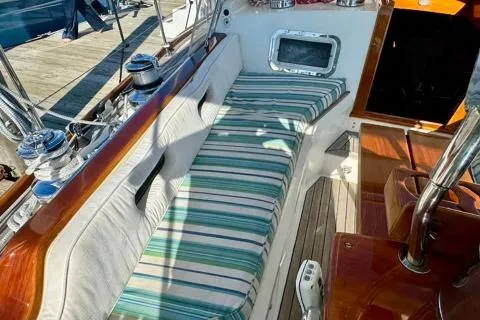 Symphony V Yacht Photos Pics 1999 Hinckley Sou'wester 52 sailboat cockpit with striped cushions and polished wood details.
