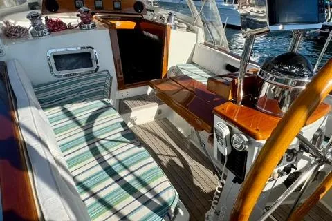 Symphony V Yacht Photos Pics 1999 Hinckley Sou'wester 52 yacht cockpit with striped seating and wooden accents.