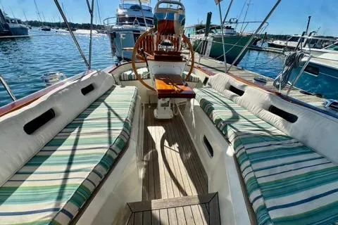 Symphony V Yacht Photos Pics Hinckley Sou'wester 52 sailboat cockpit with striped seating, docked in a marina, 1999 model.