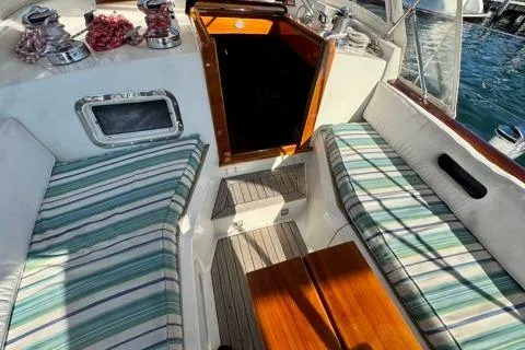 Symphony V Yacht Photos Pics Hinckley Sou'wester 52 cockpit, 1999 model, featuring striped seating and wooden accents.