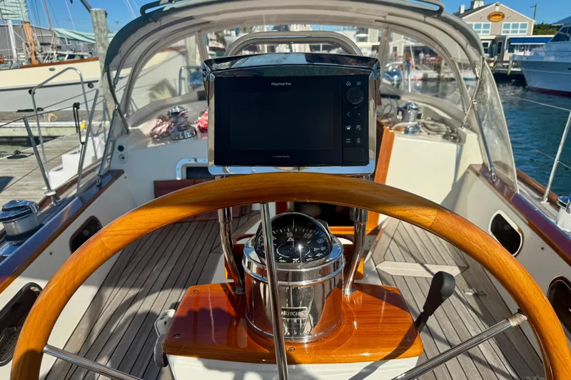 Symphony V Yacht Photos Pics Hinckley Sou'wester 52 yacht cockpit with wooden wheel and navigation equipment, 1999 model.