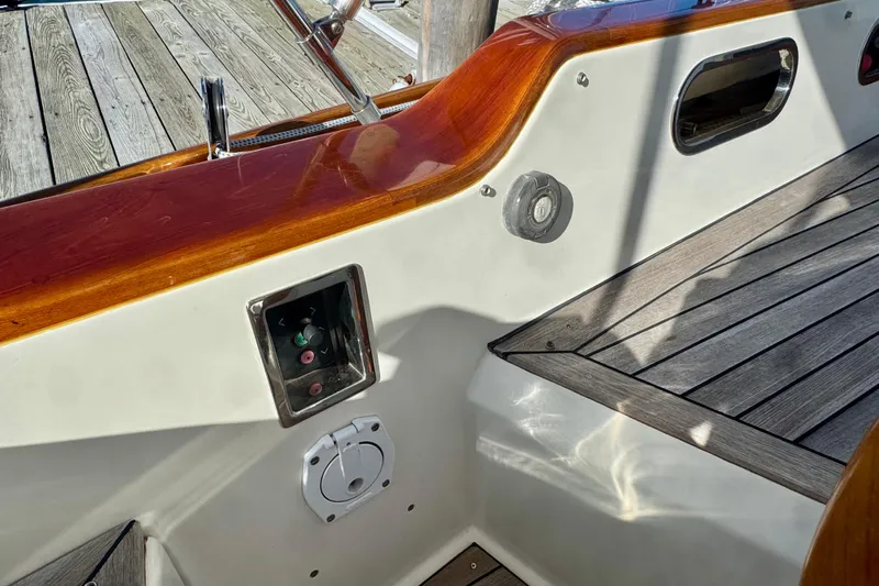 Symphony V Yacht Photos Pics Cockpit detail of 1999 Hinckley Sou'wester 52 sailboat with wood trim and control panel.