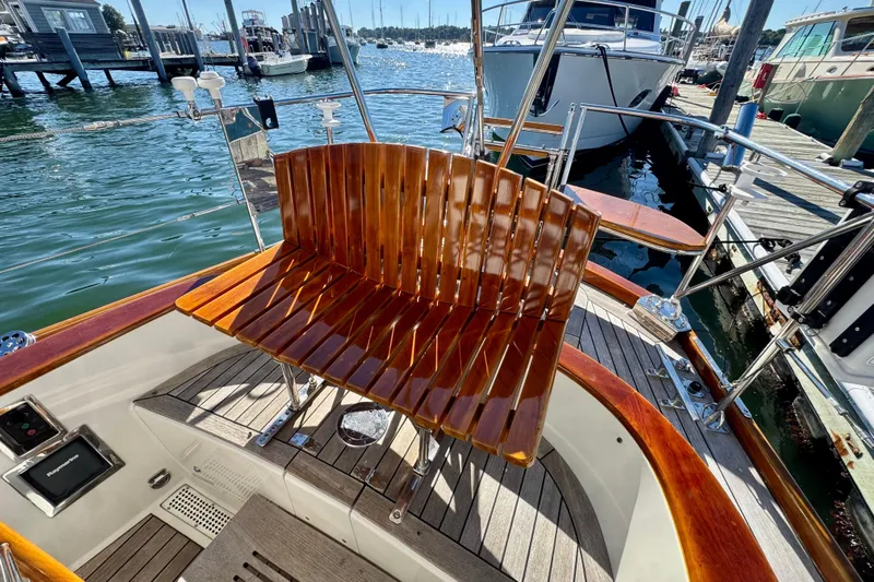 Symphony V Yacht Photos Pics Hinckley Sou'wester 52 yacht, 1999 model, featuring polished wooden seating and deck at a marina.