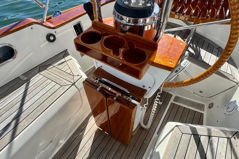 Symphony V Yacht Photos Pics Cockpit of 1999 Hinckley Sou'wester 52 sailboat with wooden steering wheel and compass.
