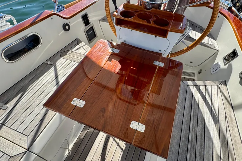 Symphony V Yacht Photos Pics Hinckley Sou'wester 52 cockpit with wooden table and steering wheel, 1999 model.