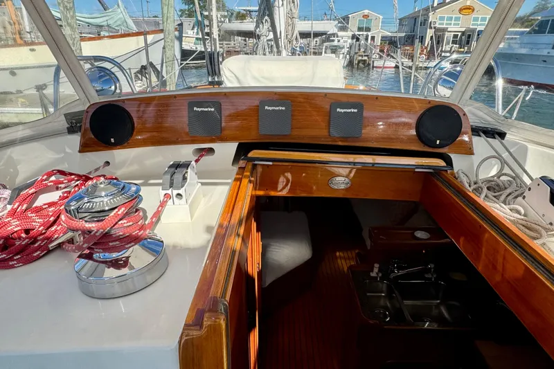 Symphony V Yacht Photos Pics Hinckley Sou'wester 52 cockpit, featuring navigation equipment and ropes, docked at a marina.