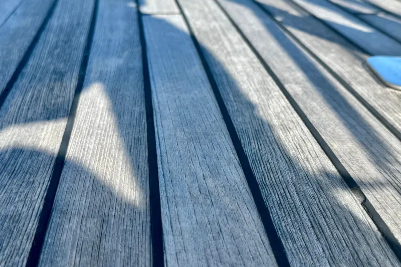 Symphony V Yacht Photos Pics Teak deck of 1999 Hinckley Sou'wester 52 sailboat with shadows.