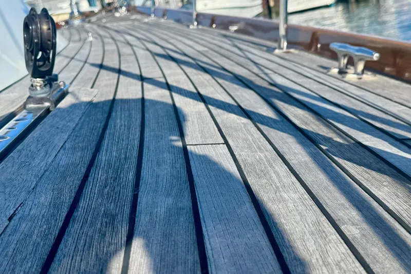 Symphony V Yacht Photos Pics Teak deck of 1999 Hinckley Sou'wester 52 sailboat, showcasing elegant craftsmanship.