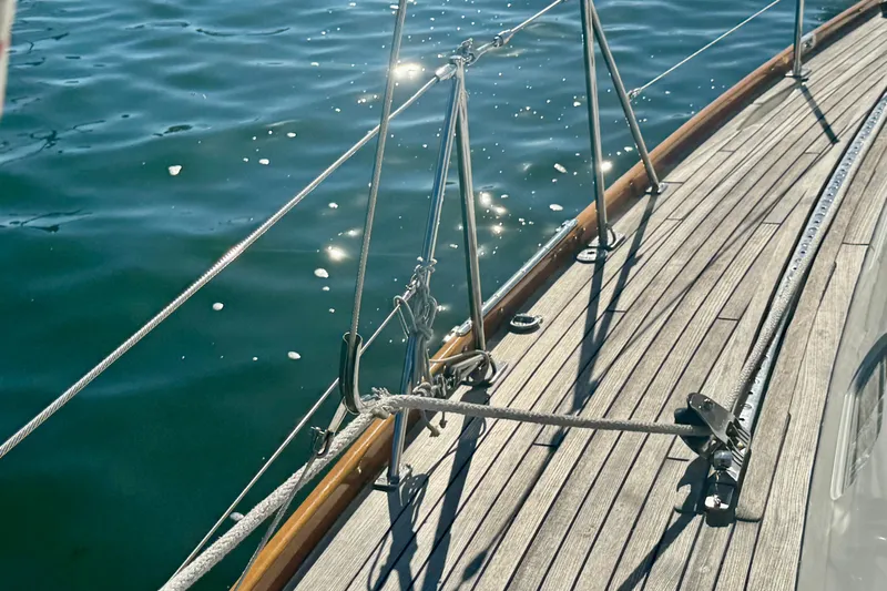 Symphony V Yacht Photos Pics Deck of 1999 Hinckley Sou'wester 52 sailboat with sunlit water reflections.