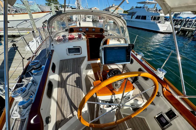Symphony V Yacht Photos Pics Cockpit of 1999 Hinckley Sou'wester 52 sailboat with wooden wheel and navigation equipment.