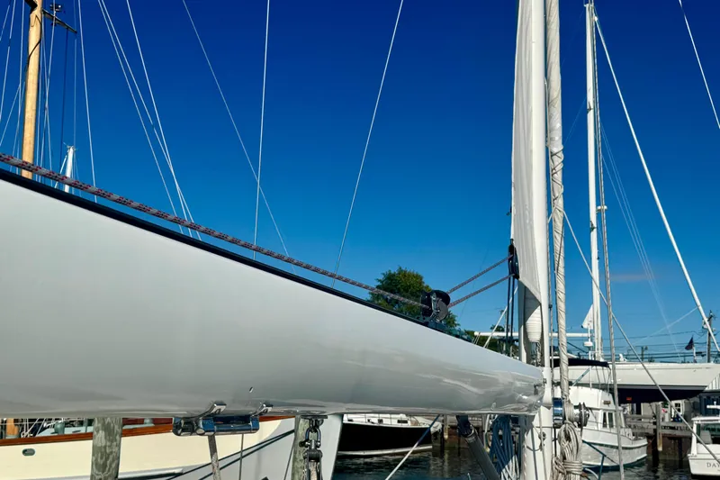 Symphony V Yacht Photos Pics Hinckley Sou'wester 52 sailboat, 1999 model, docked with clear blue sky background.