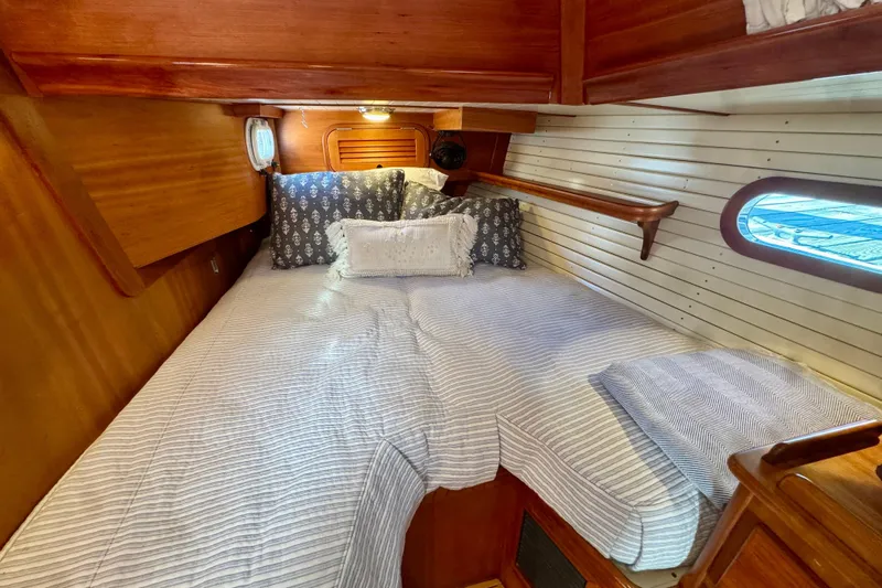 Symphony V Yacht Photos Pics Cozy cabin interior of 1999 Hinckley Sou'wester 52 sailboat with wooden accents.