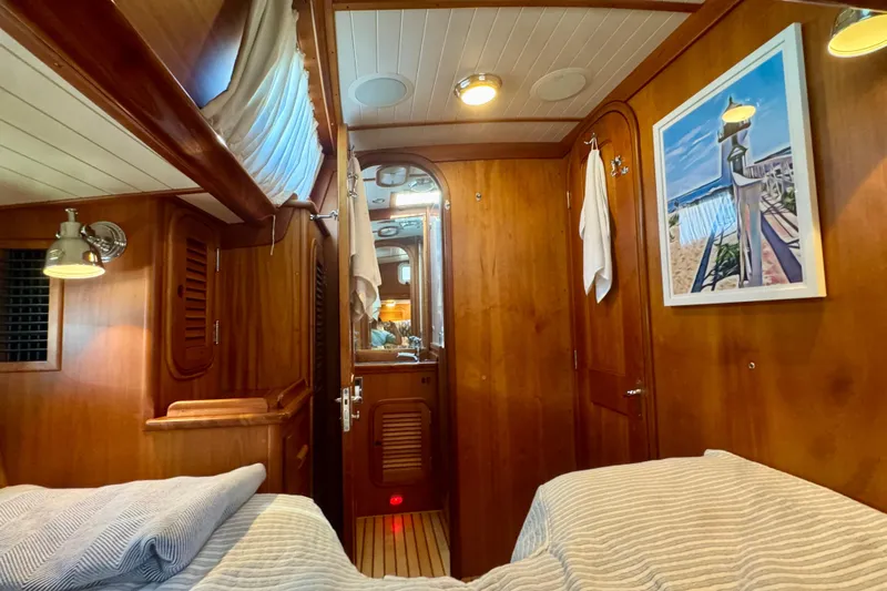 Symphony V Yacht Photos Pics Cozy wooden interior of 1999 Hinckley Sou'wester 52 yacht cabin with nautical decor.